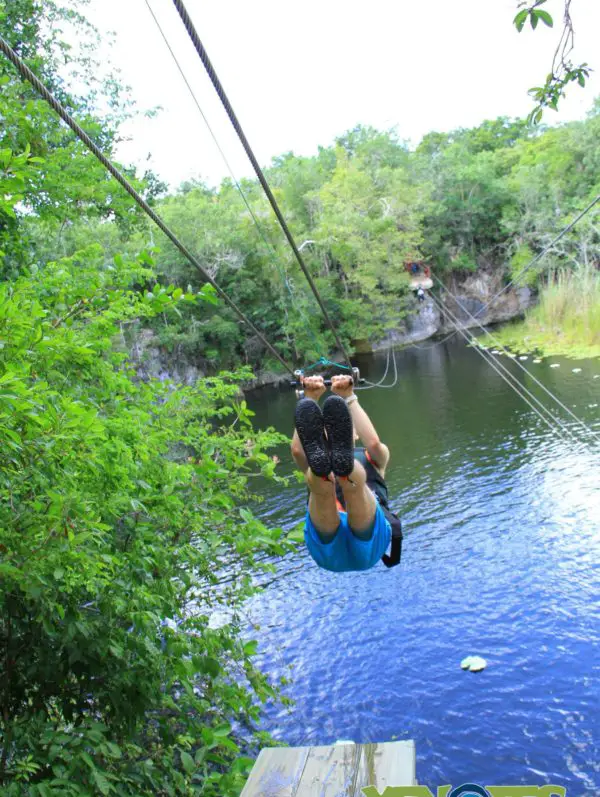 A photo of a man holding zip wire cenotes