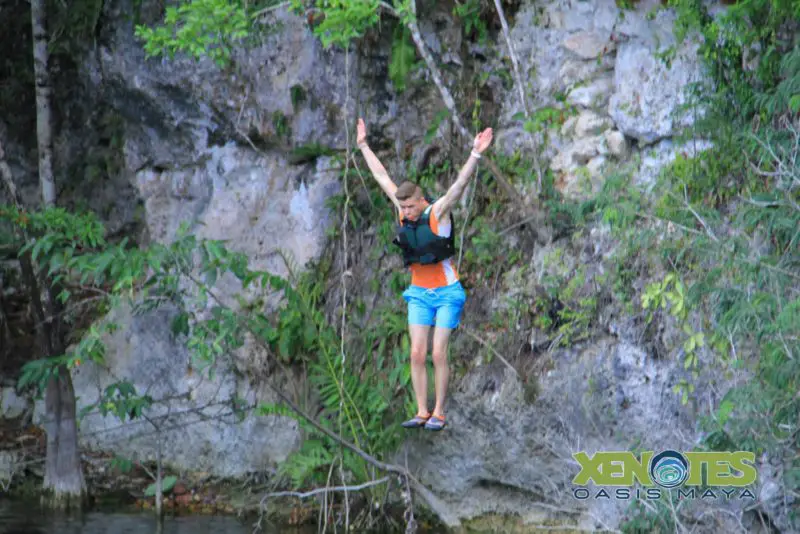 A photo of a man jumping off beside the cliff