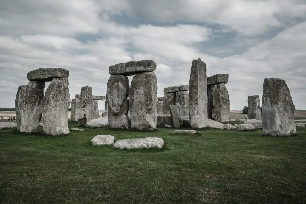 view of the ancient stone circle at stonehenge, with a cloudy grey sky in the background