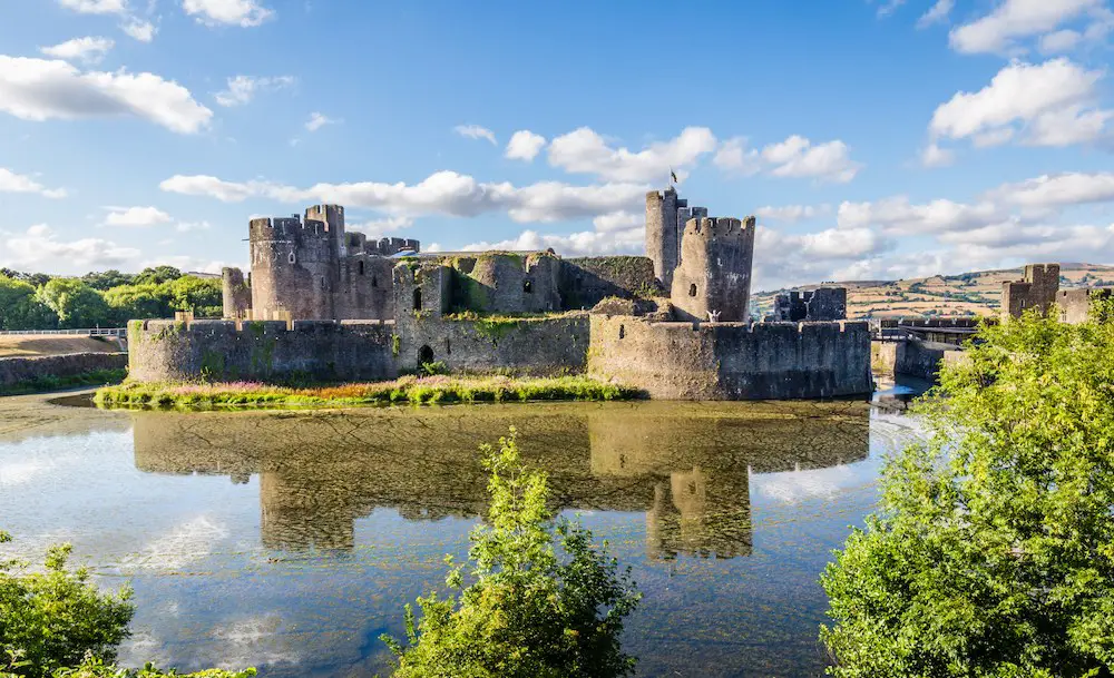 view of caerphilly castle and surrounding moat and greenery