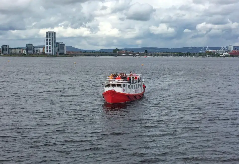 a red and white tourist boat on the bay