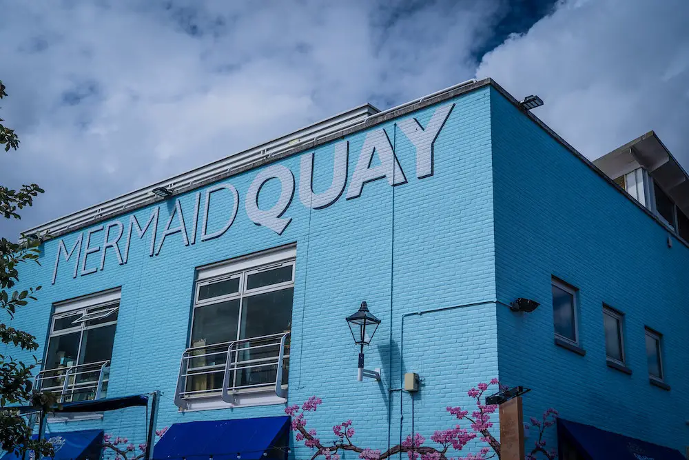 bright blue mermaid quay building