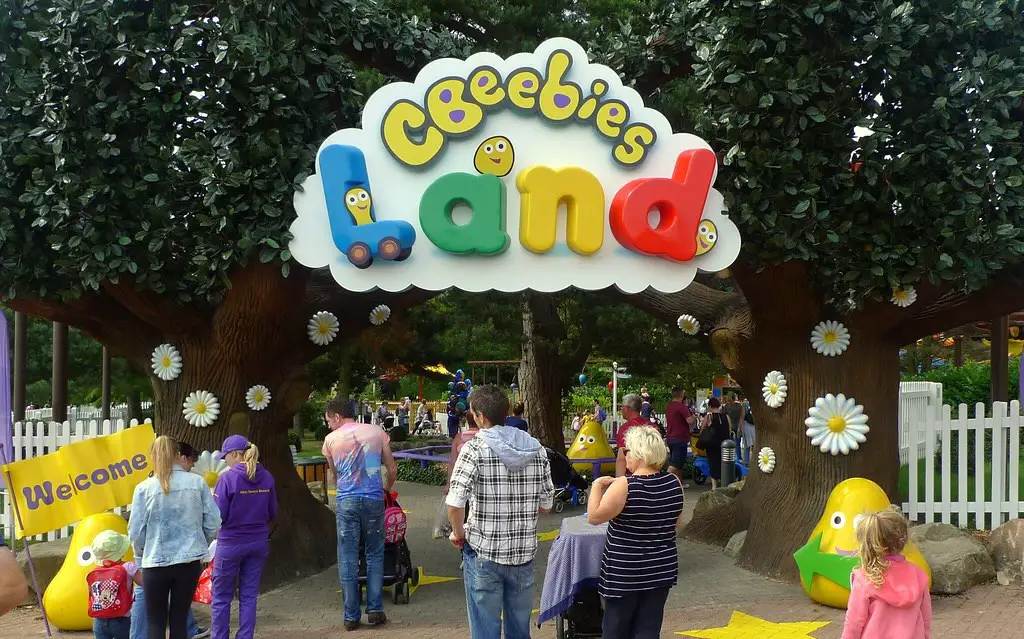 entrance to cbeebies land with people walking through, at alton towers theme park