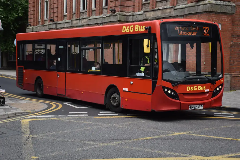 a red bus on a route in england