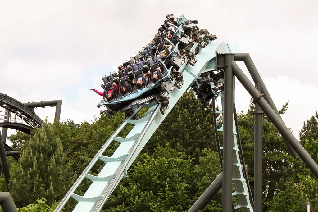 a rollercoaster twisting and moving fast with people on the ride, at alton towers theme park