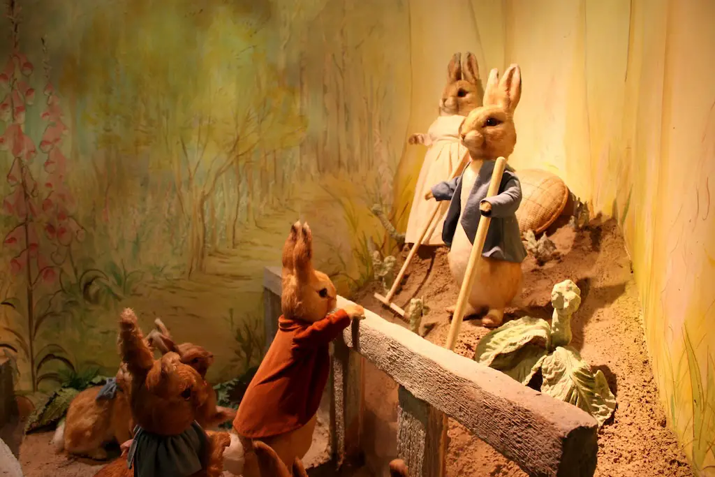 This picture: Peter Rabbit with some little rabbits at garden figurines.