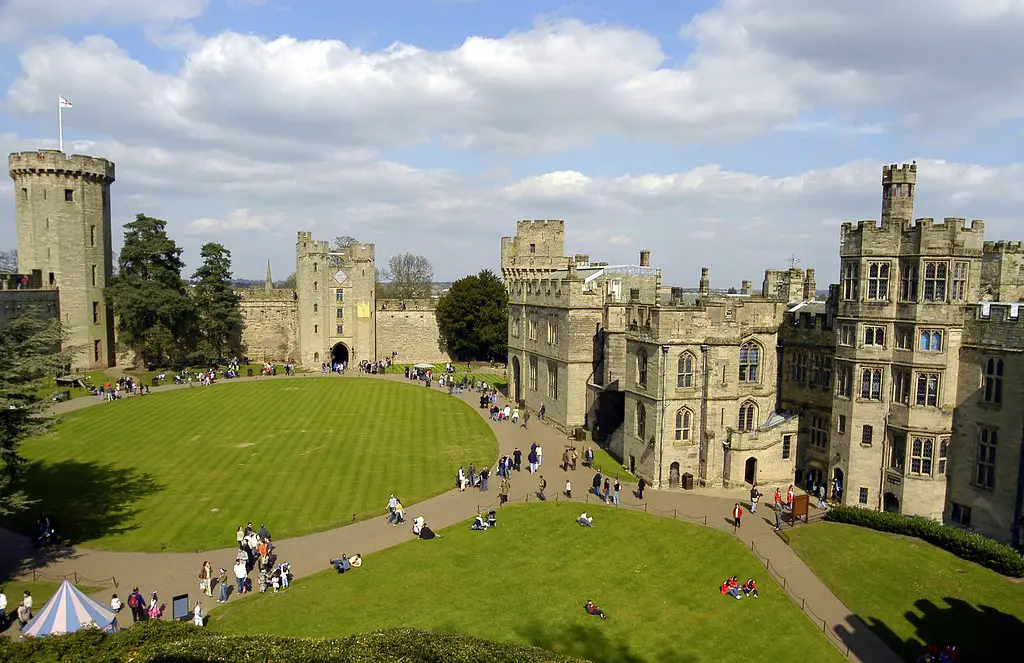 an aerial view of the inside grounds of warwick castle with people walking around