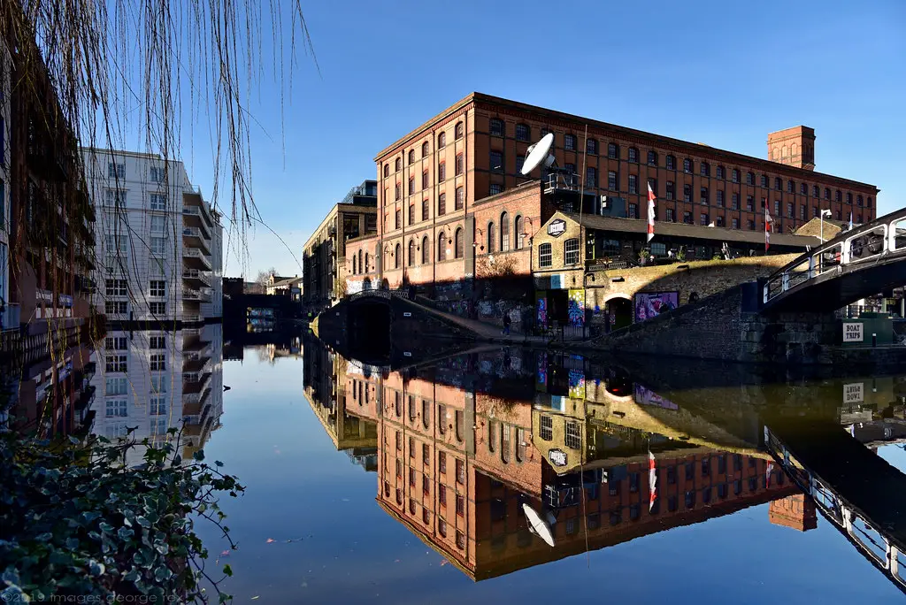 buildings around camden locks in london with views of the reflections in the water