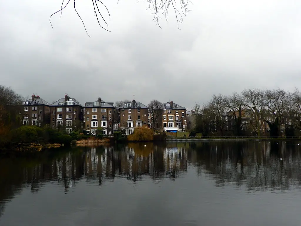 a view of large town houses on the banks of the river in london on a cold day