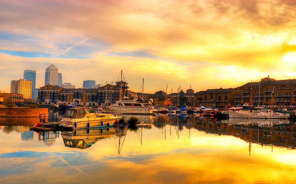 golden sunset reflected on the water at limehouse basin, london