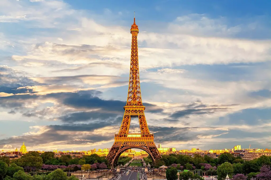 wide view of the eiffel tower glowing in the late afternoon sun in paris, france
